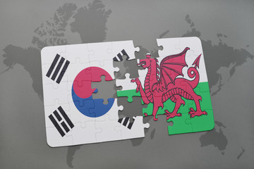puzzle with the national flag of south korea and wales on a world map background.