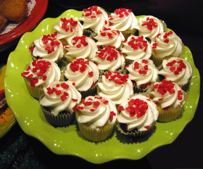 Cupcakes decorated with tiny maple leaves for Canada day.