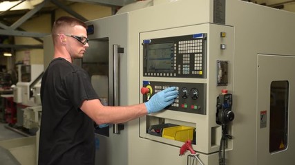 man programming a cnc machine