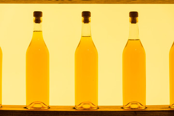 Abstract Yellow Clear Glass Bottles Shelf Backlit