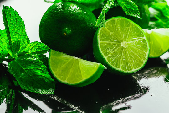 Fresh green mint and lime close-up on a dark background