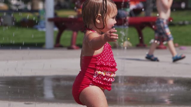 Slow motion shot of young girls playing in water park - 4k