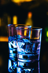 Two glasses of vodka with ice closeup
