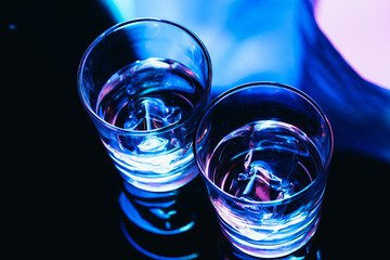 drinking glasses with ice close-up on a dark background