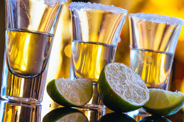 stack of tequila with salt close up on blurred background