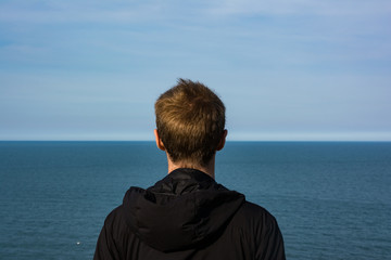 Young Male Looking to Horizon Ocean Landscape Abstract