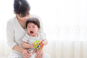 portrait of asian mother holding baby