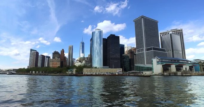 A daytime low angle establishing shot of the lower Manhattan skyline as seen from New York harbor.	 	