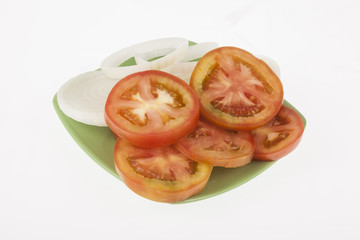 onion slices and tomato slices on neutral background