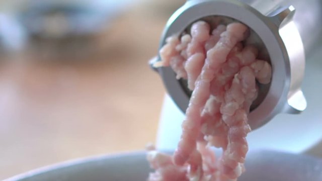 Action of mincer machine with fresh chopped meat