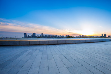 cityscape and skyline of harbin from empty brick floor