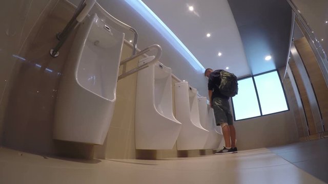 Man Urinate or Pee in Public Toilet