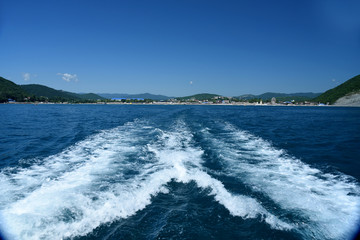 Summer travel to the black sea. Boiling blue water after boat