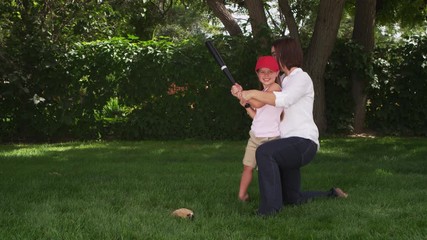 Mother and daughter playing baseball in the park - 4k
