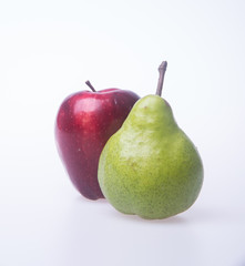 red apple and green pear on a background.