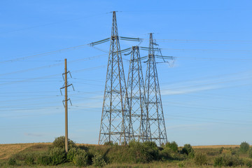 Electric high voltage poles on the plain side view