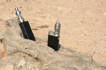 Electronic cigarette at the root of the tree