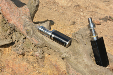 Electronic cigarette at the root of the tree