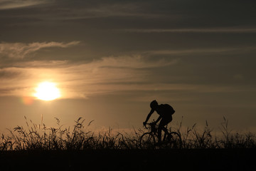 Riding a bike in sunset - 118946279