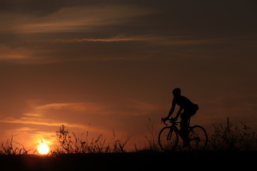 Riding a bike in sunset - 118946285
