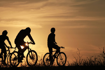 Riding a bike in sunset - 118946298