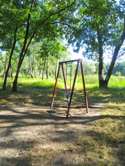 Empty children's playground in the birch forest