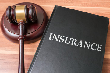 Book with insurance laws. Justice and legislation concept.