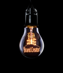 Hanging lightbulb with glowing Brand Creator concept.