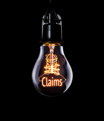 Hanging lightbulb with glowing Claims concept.