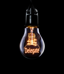 Hanging lightbulb with glowing Delegate concept.
