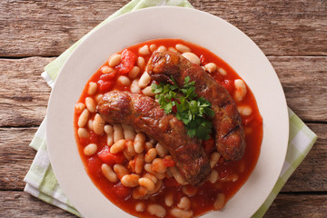 Beans with grilled sausage, traditional european homemade meal. Horizontal top view
