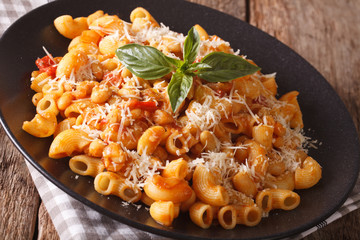 pasta with tomatoes, beans and parmesan cheese on a plate close-up. horizontal
