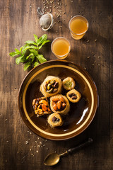 Fototapeta na wymiar Delicious knafeh on brown plate with tea