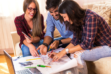 Teamwork. Three young architects working on a project. Startup concept.