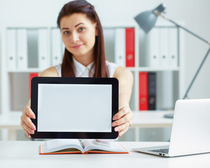 Woman holding tablet with copy space for text or picture. Stylish modern office workplace on a background.
