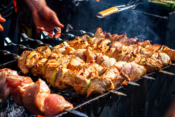 Grilling marinated shashlik preparing on a barbecue grill over charcoal. Shashlik is a form of Shish kebab popular in Eastern Europe. Shashlyk (meaning skewered meat) was originally made of lamb.