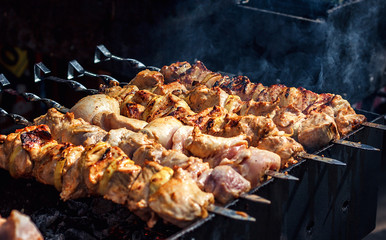 Grilling marinated shashlik preparing on a barbecue grill over charcoal. Shashlik is a form of Shish kebab popular in Eastern Europe. Shashlyk (meaning skewered meat) was originally made of lamb.