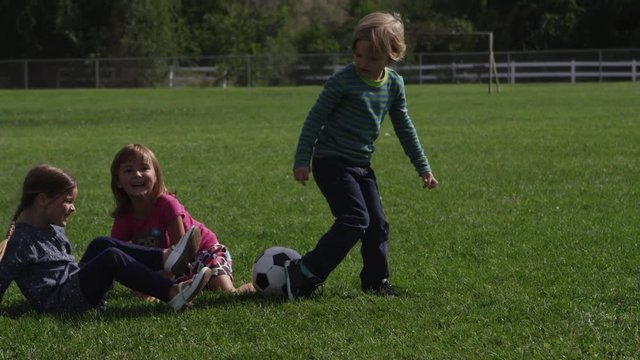 Little children playing football at school - 4K