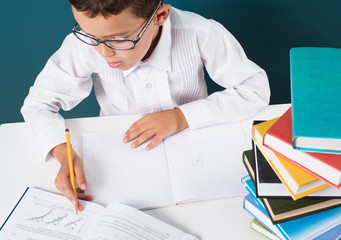 Pensive cute boy with homework sitting