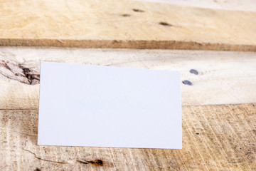 White blank business visit card, gift, ticket, pass, on wooden table. 