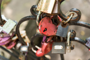 Padlock in combination with ropes, threads and scraps of fabric.