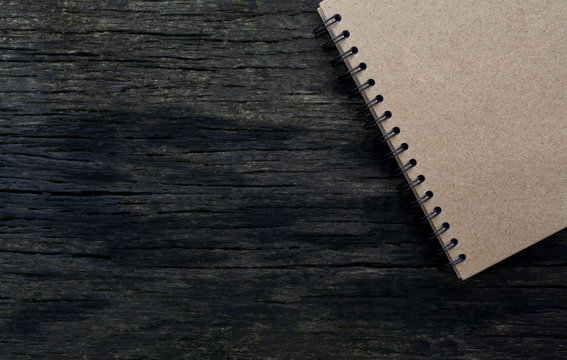 brown notebook on wood background