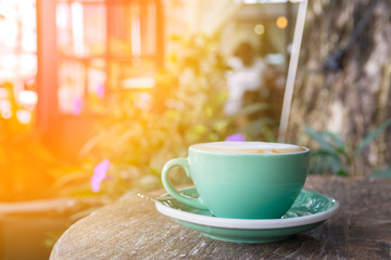 green coffee cup on wooden table