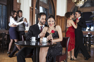Fototapeta premium Happy Couple With Rose Smiling While Enjoying Tango Performance