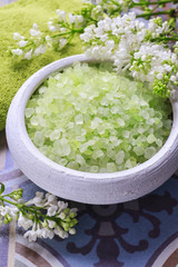 Green sea salt and lilac flowers