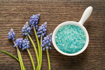 Bowl of blue sea salt on brown wood