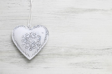 White heart on white wooden background