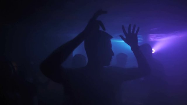 Dancing silhouette of man in a nightclub. HD.