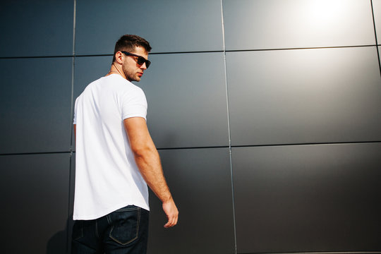 Hipster wearing white blank t-shirt with space for your logo