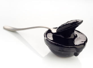 spoon with concentrated paste squid ink on white